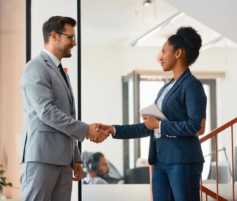 Handshake between professionals representing financial and advisory services in wealth management.